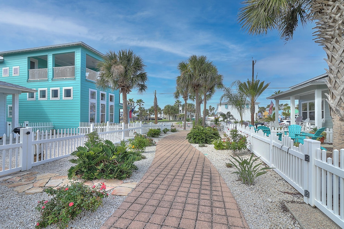 Charming coastal property featuring tropical landscaping and vibrant architecture in a peaceful beachside community.