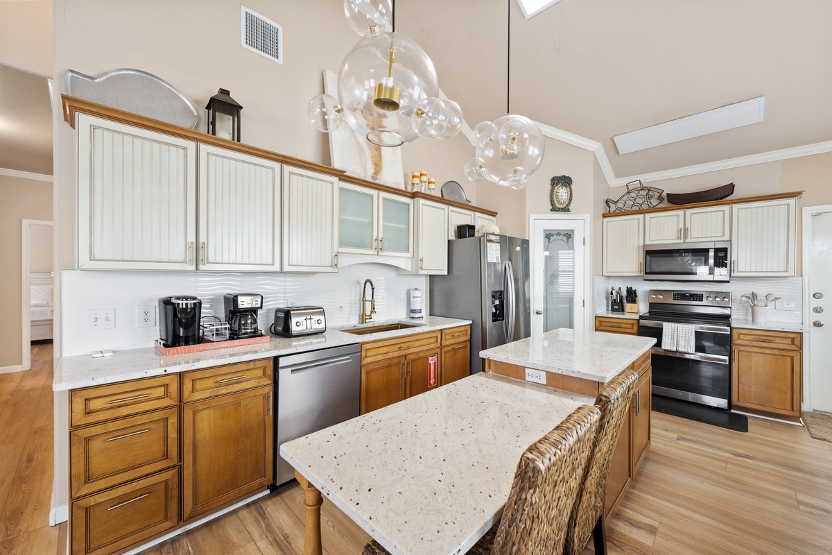 Prepare meals with ease in the fully equipped kitchen featuring generous counter space, modern appliances, and a convenient center island.