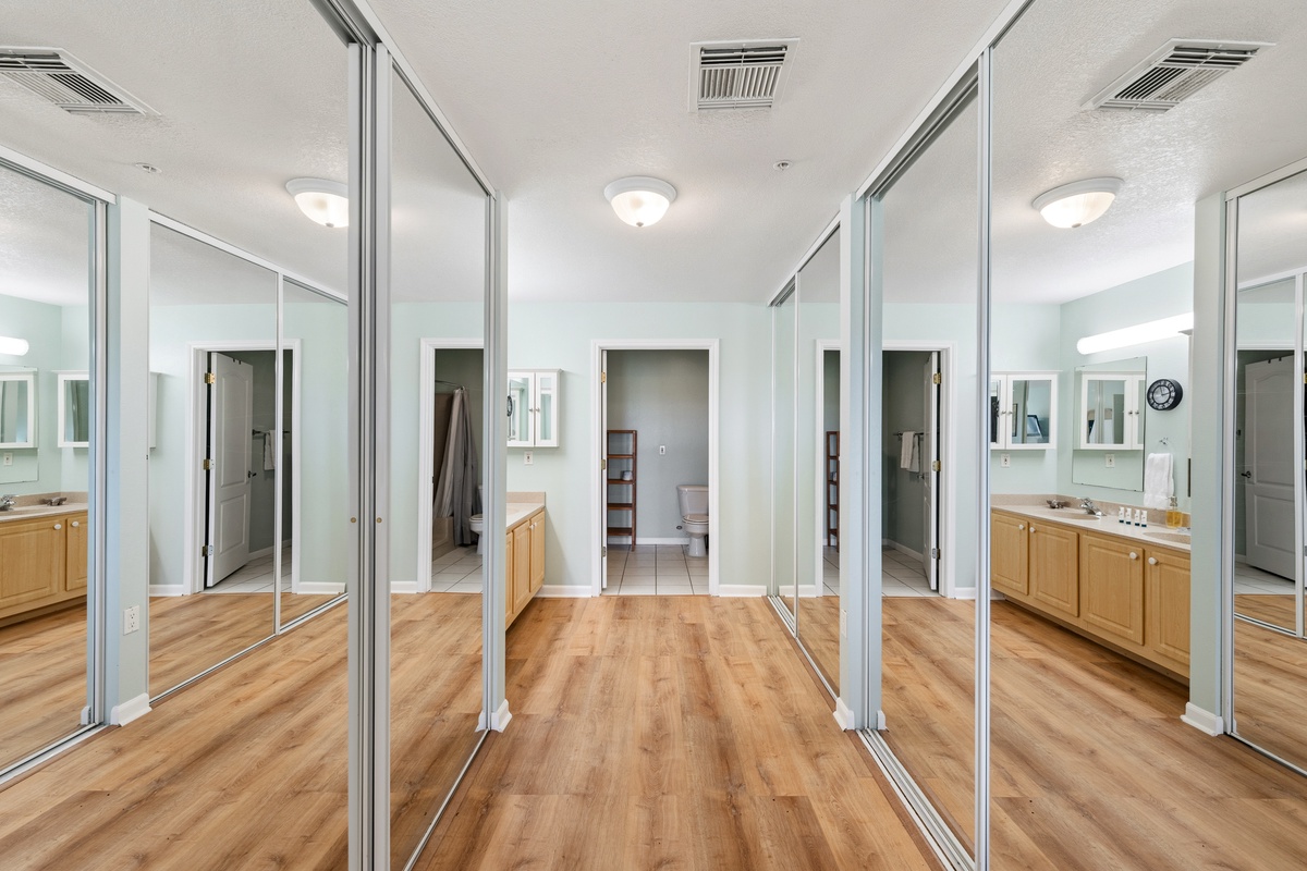 Floor-to-ceiling mirrored closets frame your bedroom hallway, offering abundant storage and an airy, open feel as you step into your private retreat.