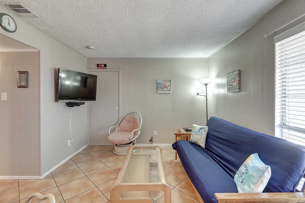 Settle into your cozy living space with comfortable seating and entertainment ready for relaxing evenings after beach adventures.