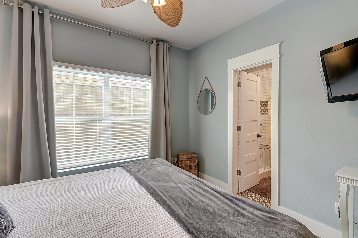 Drift off in this serene bedroom with soft gray walls and your private ensuite bathroom just steps away from your cozy bed.