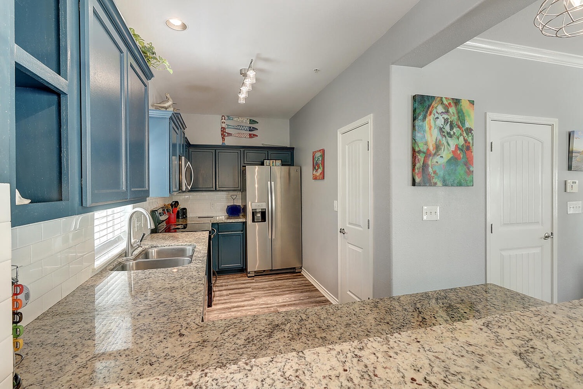 Your fully equipped kitchen features granite countertops and stainless steel appliances, perfect for preparing meals during your stay.
