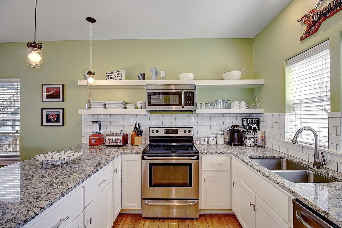 Cook memorable meals in this bright, fully-equipped kitchen featuring granite countertops, modern appliances, and everything you need for your stay.