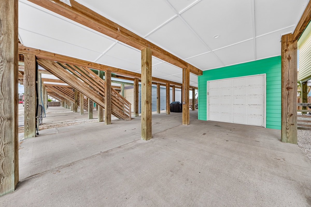 This elevated parking area offers covered protection under the property with secure garage access and sturdy construction for your peace of mind.