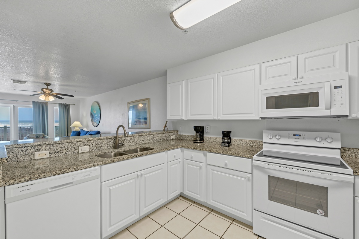 Your fully-equipped kitchen features granite countertops, modern appliances, and ocean views—perfect for preparing meals while enjoying the coastal scenery.