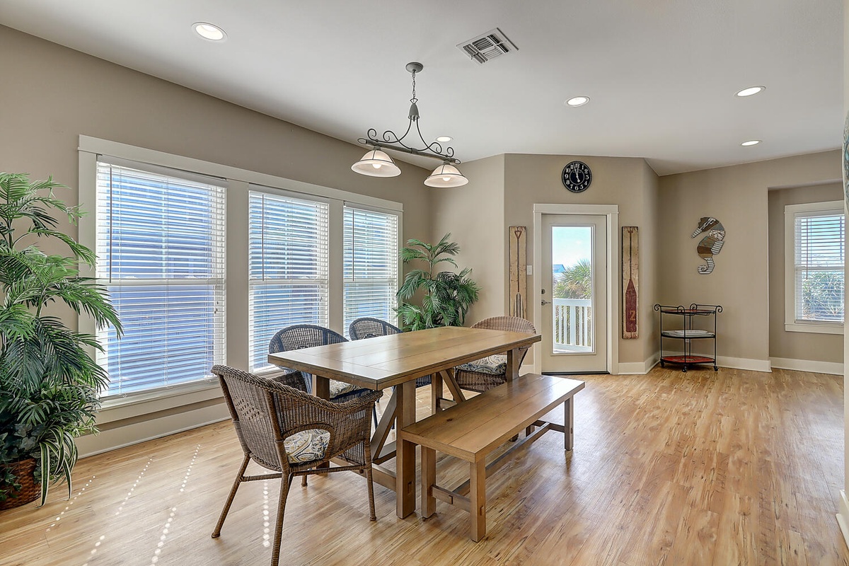 Gather around this inviting dining table where warm wood tones and natural light create the perfect setting for memorable meals together.