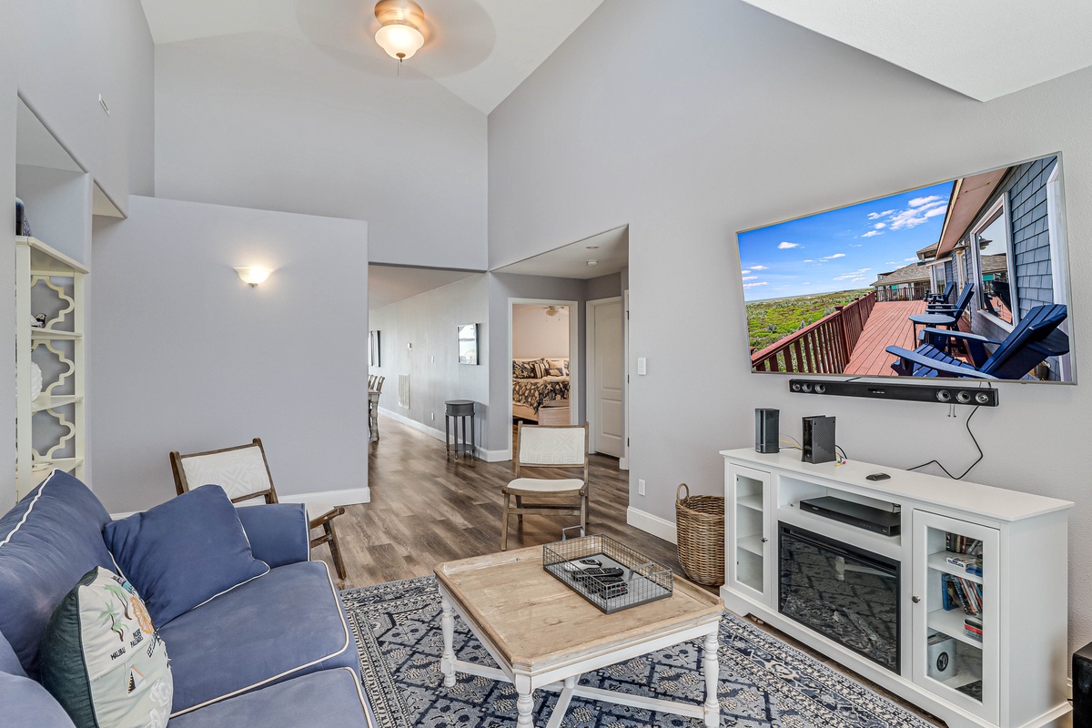 Unwind in your stylish living room featuring plush seating, modern entertainment center, and contemporary coastal decor.