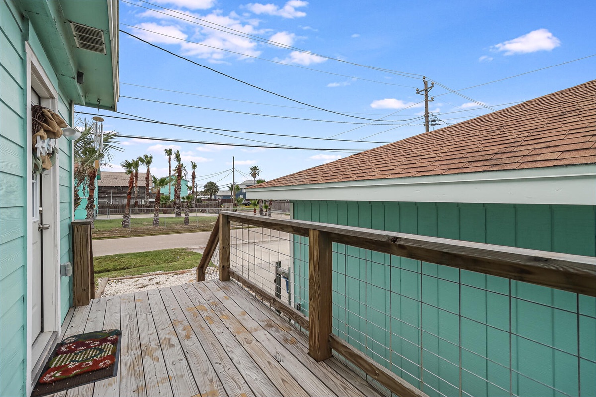 Step onto your private deck where coastal breezes meet palm-lined streets in this charming beach community setting.