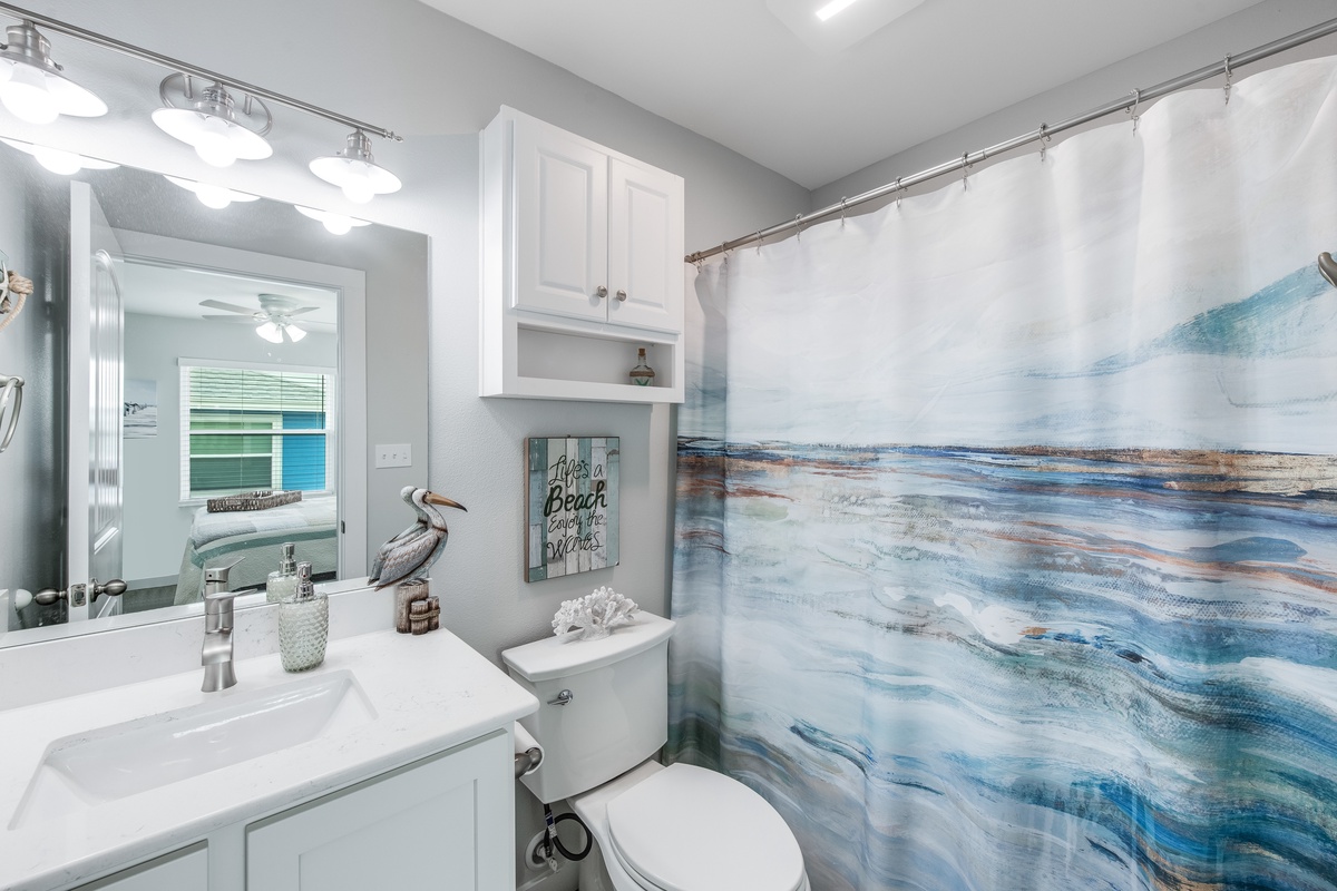 Refresh in your coastal-themed bathroom featuring ocean-inspired décor and thoughtful amenities for your beach getaway.