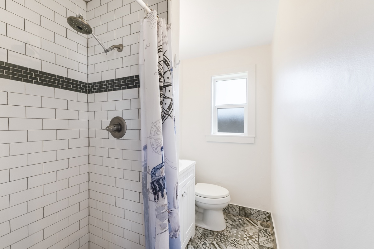 Refresh and recharge in this bright, spotless bathroom featuring a tiled walk-in shower and fresh towels for your stay.