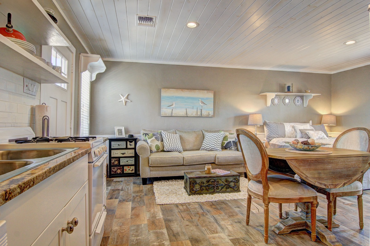 Unwind in your coastal-inspired open space where kitchen, living, and dining blend seamlessly with beachy charm and warm wood accents.