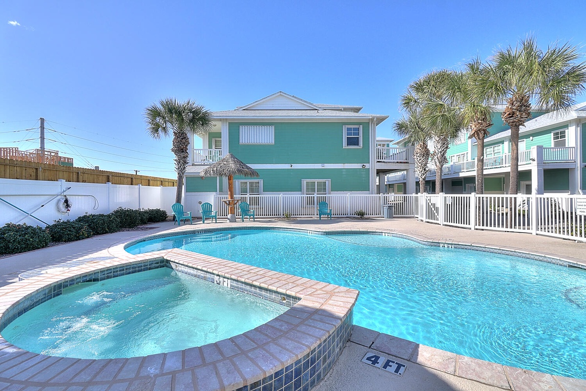 Dive into your private oasis with this sparkling pool and relaxing spa, surrounded by swaying palms and colorful coastal charm.