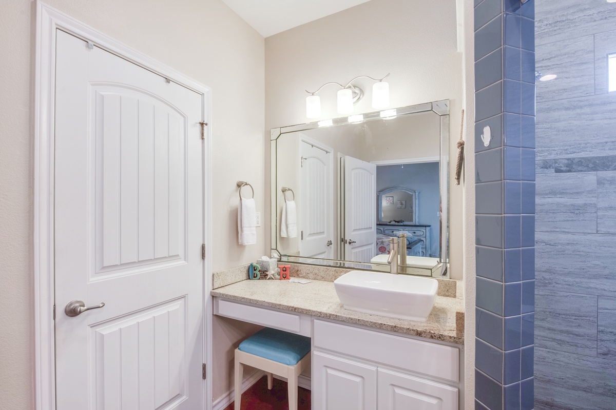 Freshen up at your stylish vanity with granite countertops and vessel sink, perfectly lit for your morning routine.