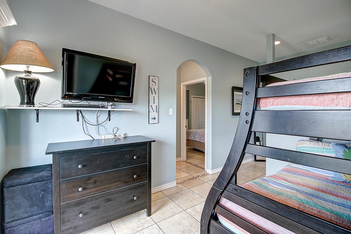 Cozy bunk bed room with TV entertainment perfect for kids or extra guests to enjoy their stay.