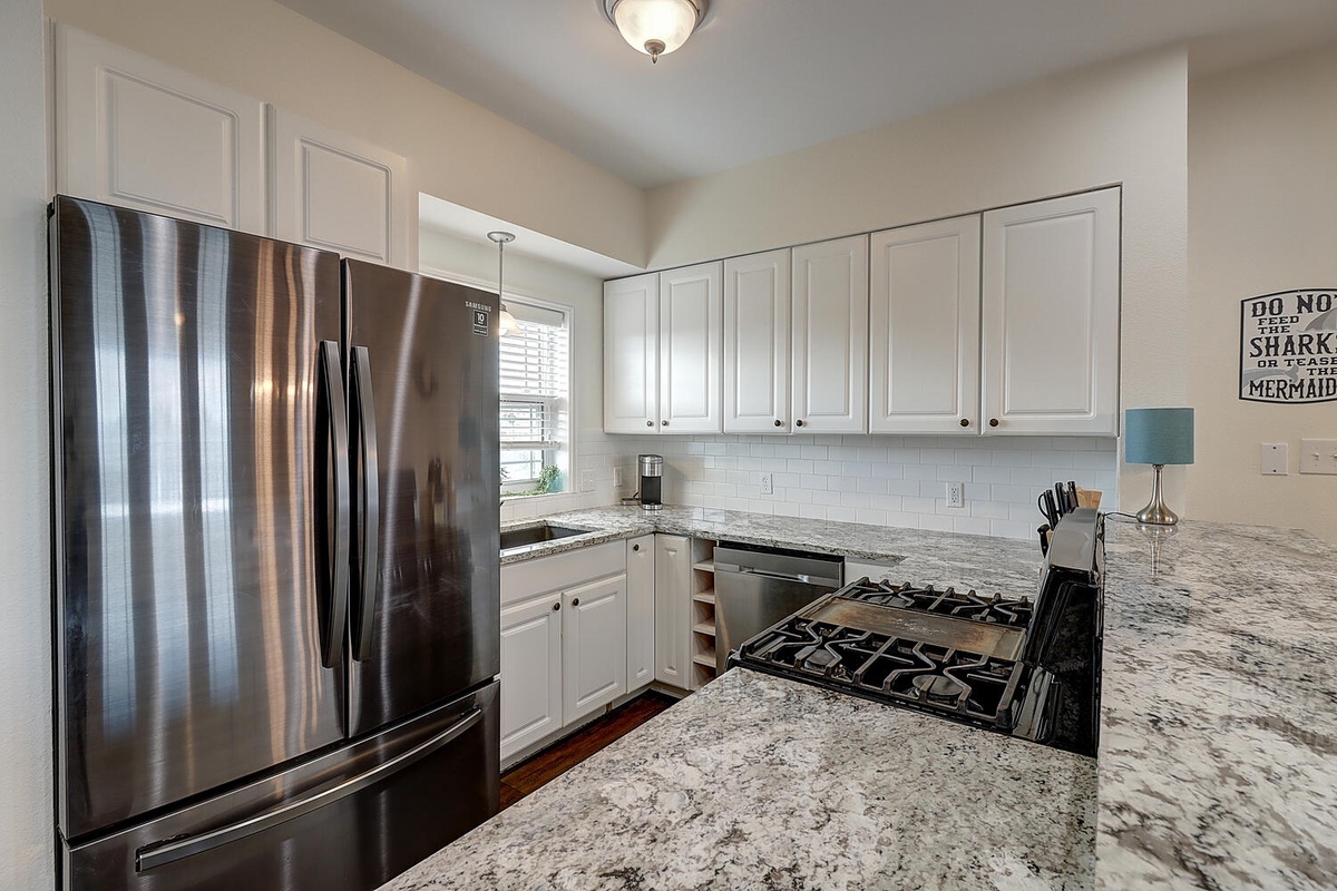 Your fully equipped kitchen features granite countertops, stainless steel appliances, and all the essentials for creating memorable meals during your stay.