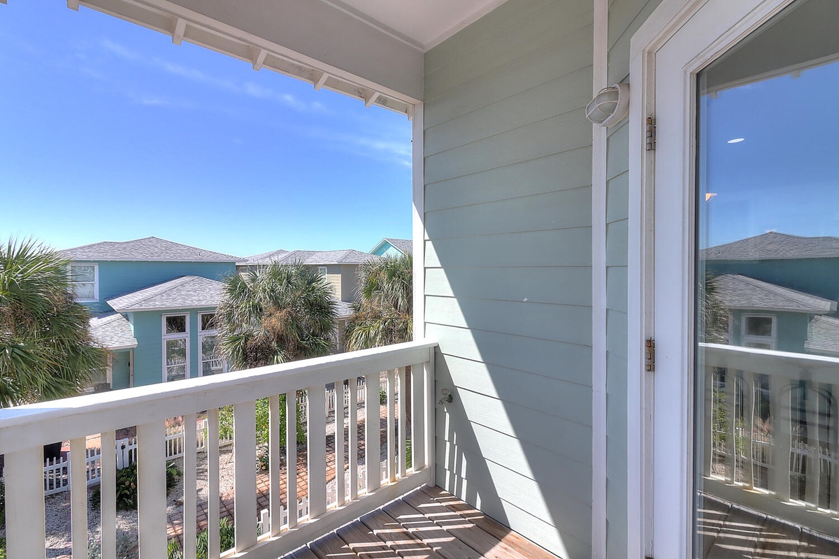 Step onto your private balcony and breathe in the coastal charm with views of palm-lined homes and blue skies.