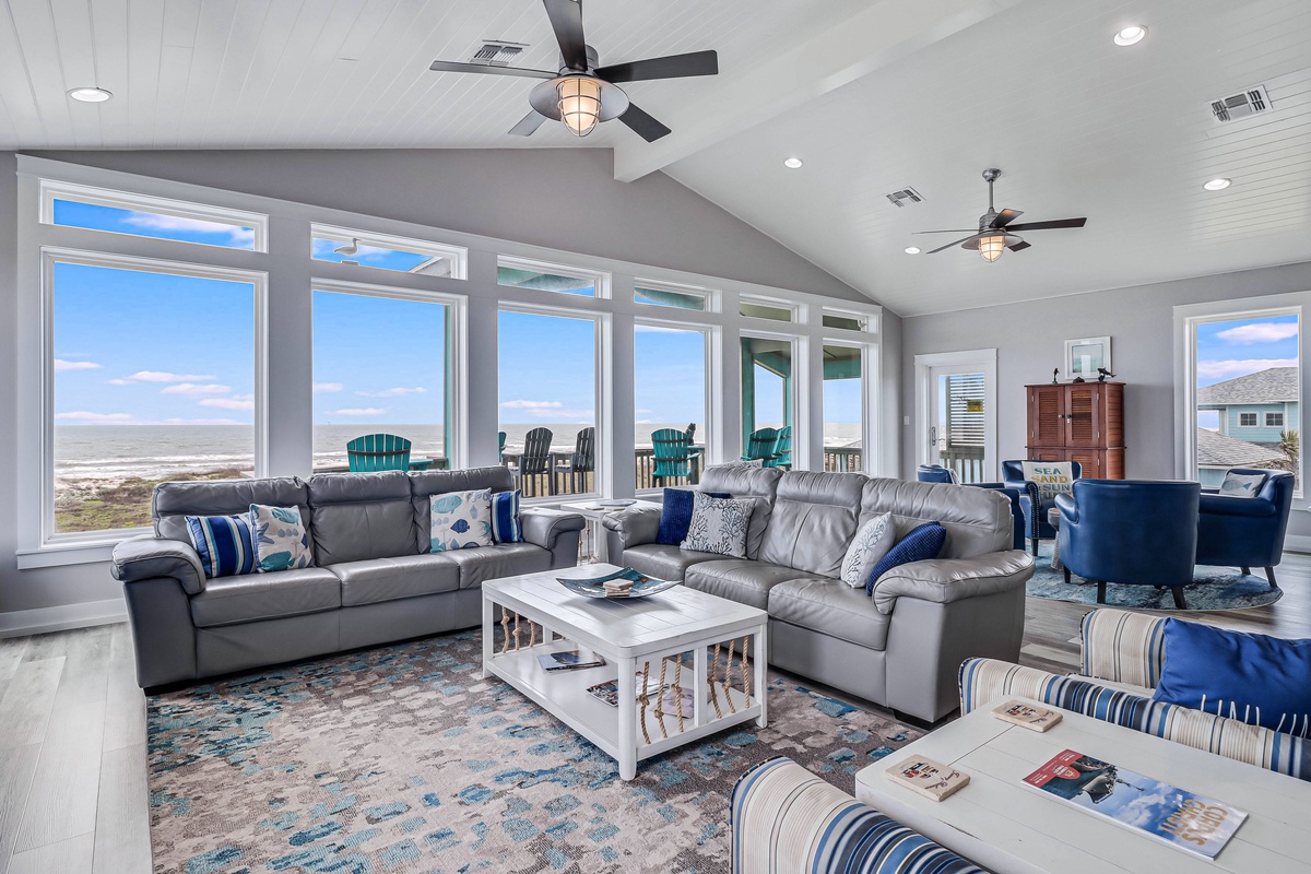 Relax in your oceanfront living room where panoramic windows frame endless sea views and coastal breezes flow through spacious comfort.