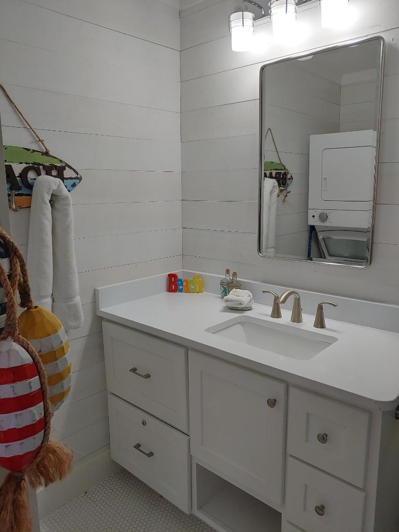 Step into your bright, clean bathroom with modern vanity, plenty of storage, and fresh towels waiting for you.