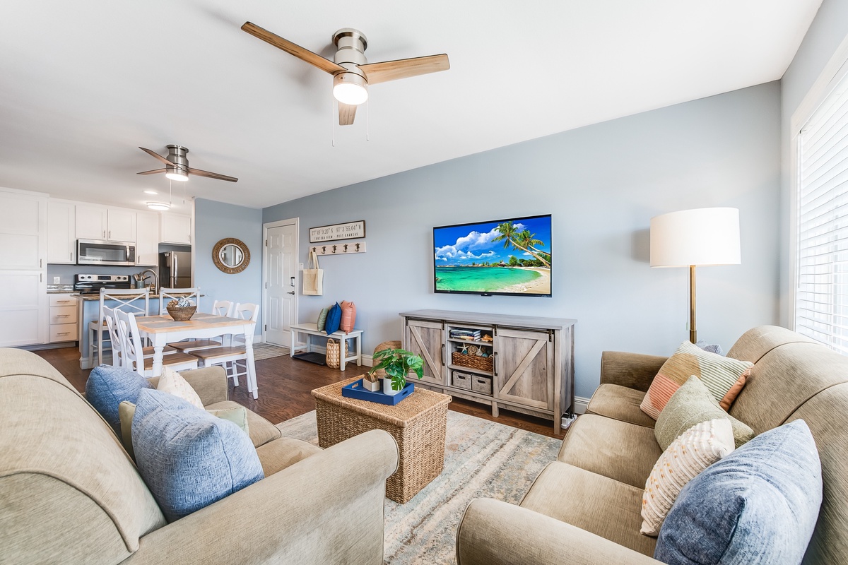 Unwind in your bright, coastal-inspired living space with plush seating, tropical TV views, and an open kitchen perfect for vacation meals.