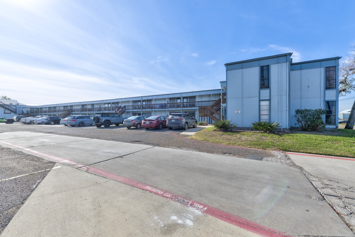 Modern two-story apartment building with convenient parking and well-maintained grounds in a quiet residential area.