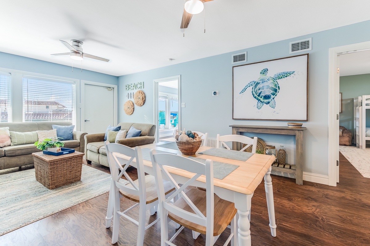 Unwind in your coastal-inspired living space where sea turtle art and ocean blues create your perfect beach retreat sanctuary.