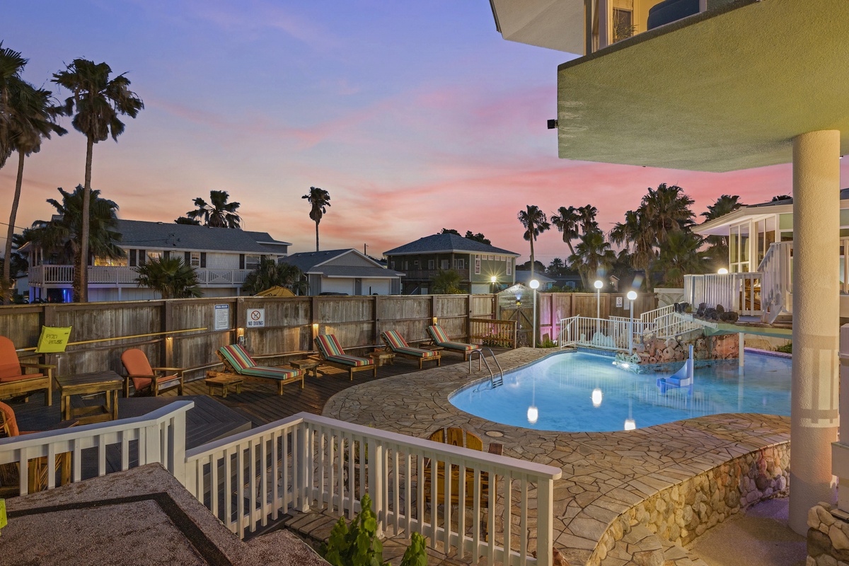 Beautiful pool area with tropical palms and colorful sunset sky creating the perfect backdrop for your evening retreat.