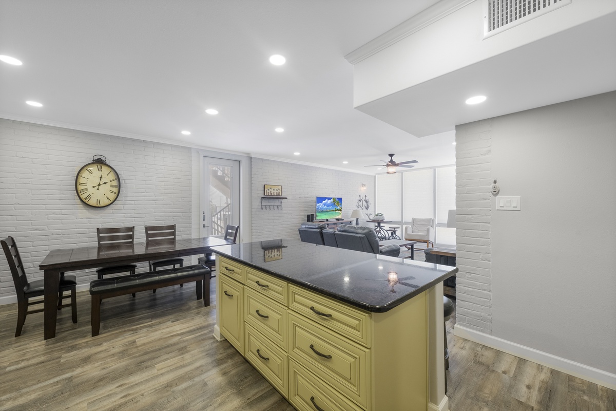 Gather around your spacious kitchen island with sleek granite countertops, perfect for meal prep or casual dining while staying connected to your living area.