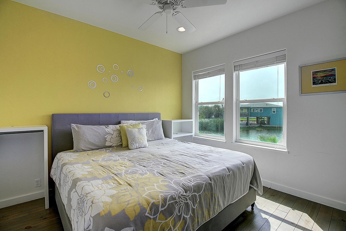 Drift into peaceful sleep in this bright bedroom with cheerful yellow accents and lake views from your window.