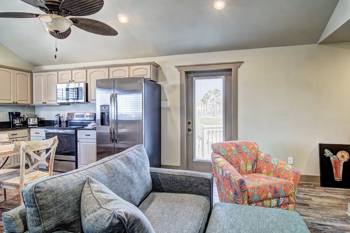 Relax in your open-concept living space where modern comfort meets home convenience, complete with full kitchen and cozy seating.