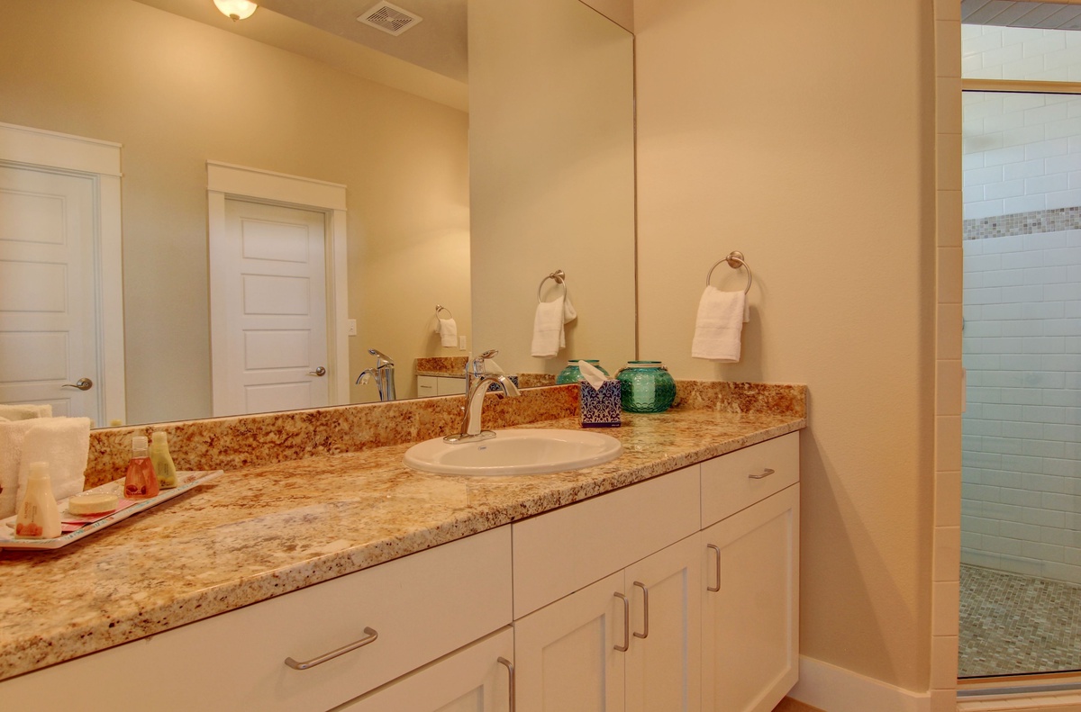 Pamper yourself in this elegant bathroom with granite countertops, spacious vanity, and fluffy towels waiting for your arrival.