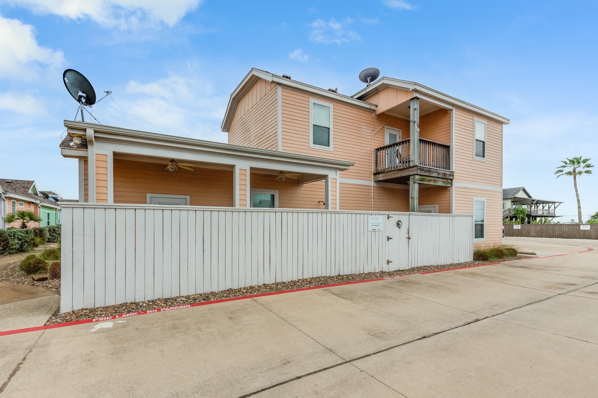 Charming coastal retreat with modern architecture and private fencing, featuring multiple levels and outdoor balcony space.