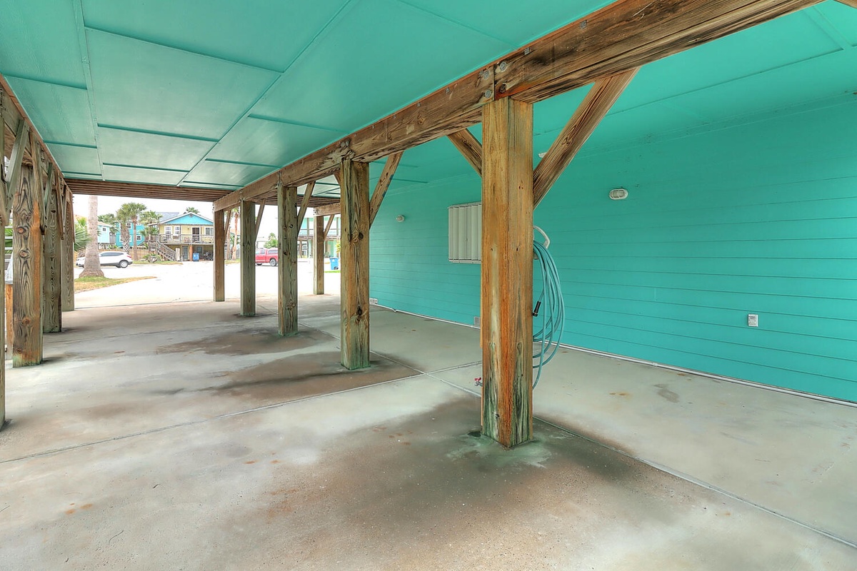 Covered parking area with rustic wooden beams provides convenient shelter for your vehicles.