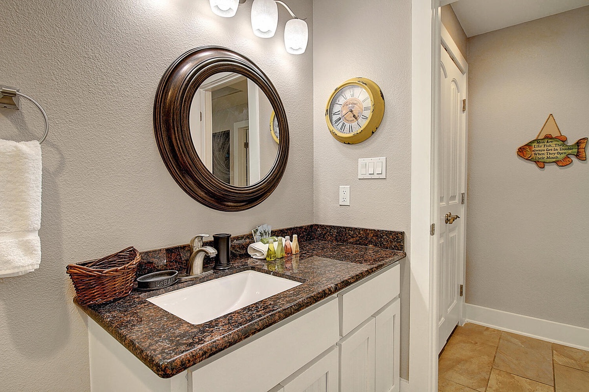 Refresh in your stylish bathroom with granite countertops, elegant vanity, and thoughtful coastal touches that make getting ready feel special.