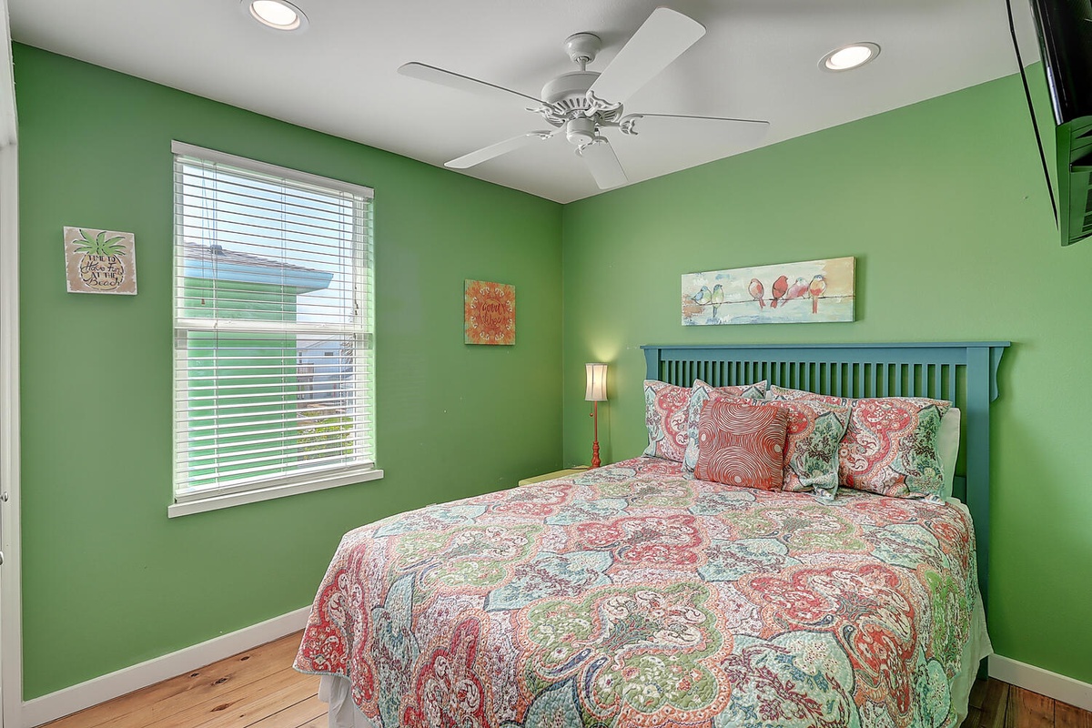 Wake up refreshed in this cheerful bedroom where vibrant green walls create an energizing atmosphere for your coastal getaway.
