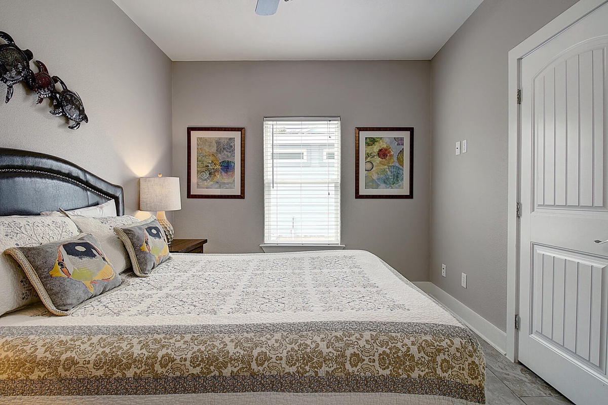 Sink into your plush bed's soft linens and enjoy natural light streaming through your window in this thoughtfully decorated bedroom retreat.