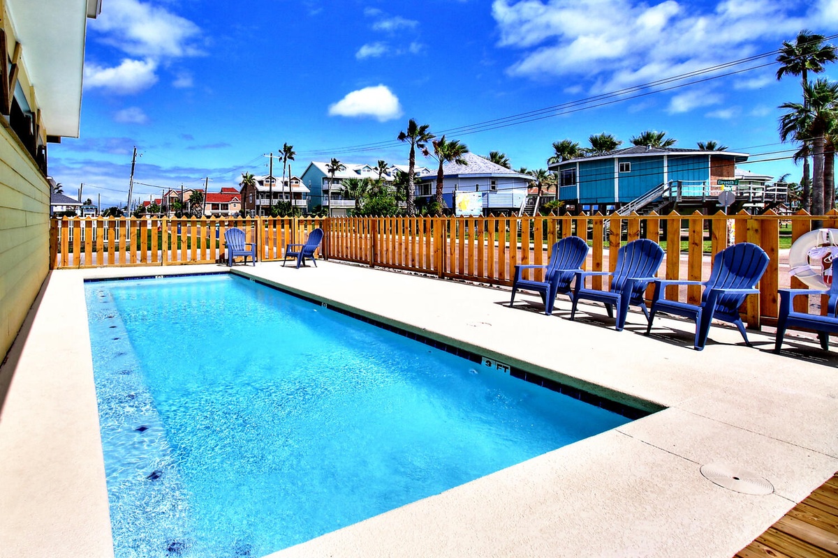 Dive into your private oasis! Crystal-clear waters await in this inviting pool, surrounded by comfortable lounge chairs and tropical charm.