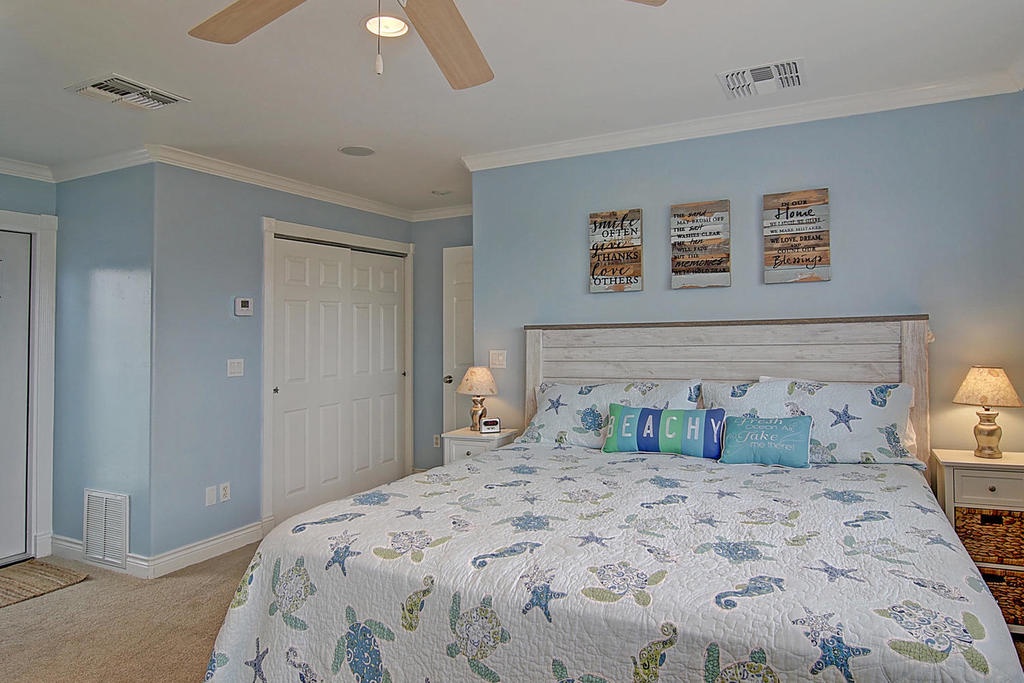 Drift off in this serene coastal bedroom featuring ocean-themed bedding and peaceful blue walls that create your perfect seaside retreat.