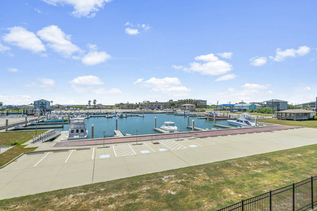Marina views showcase the coastal community's waterfront charm with boat slips and modern homes dotting the shoreline.