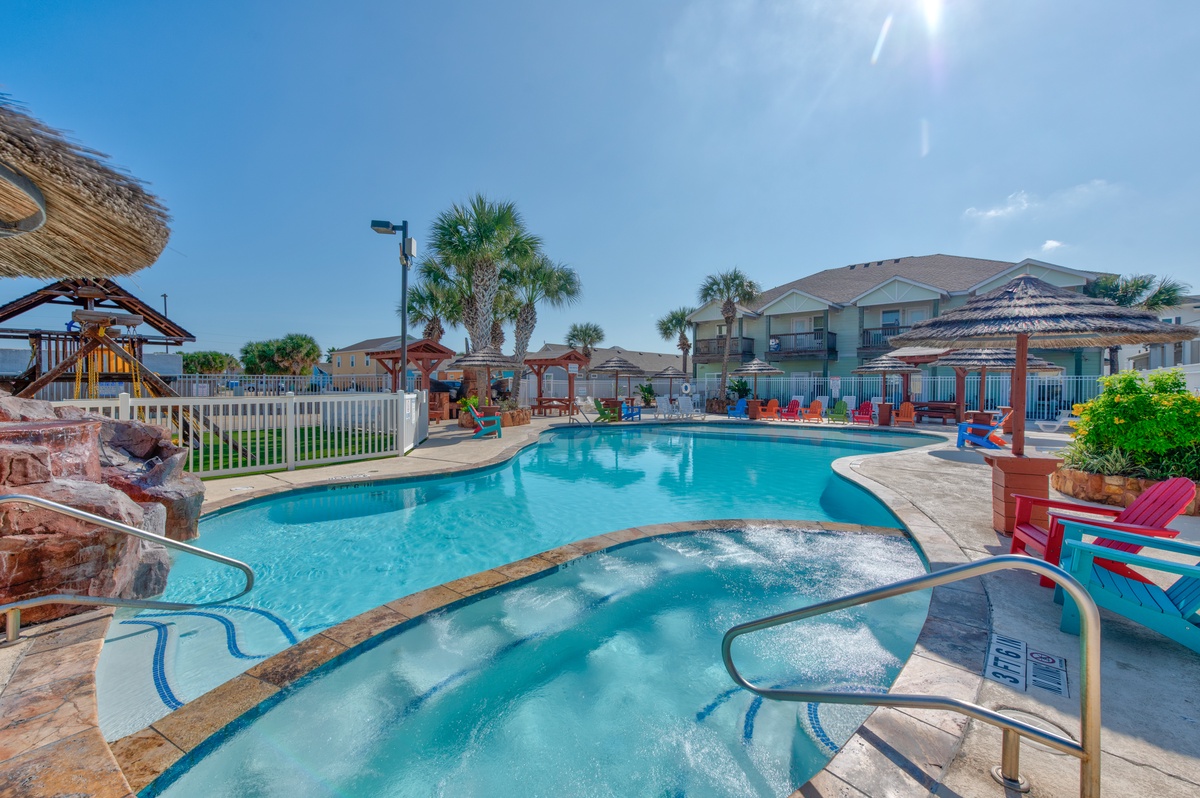 A sparkling pool and hot tub await your perfect vacation days under sunny Florida skies and swaying palms.
