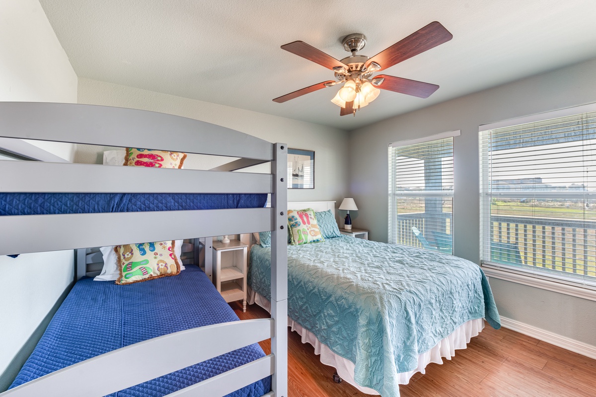 Your kids will love this cheerful bedroom with cozy bunk beds and a comfy queen bed, all bathed in natural light.