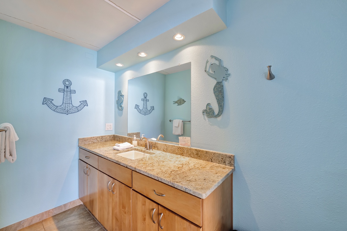Refresh in this coastal-themed bathroom with nautical charm, granite counters, and thoughtful touches that make your morning routine feel like a seaside escape.