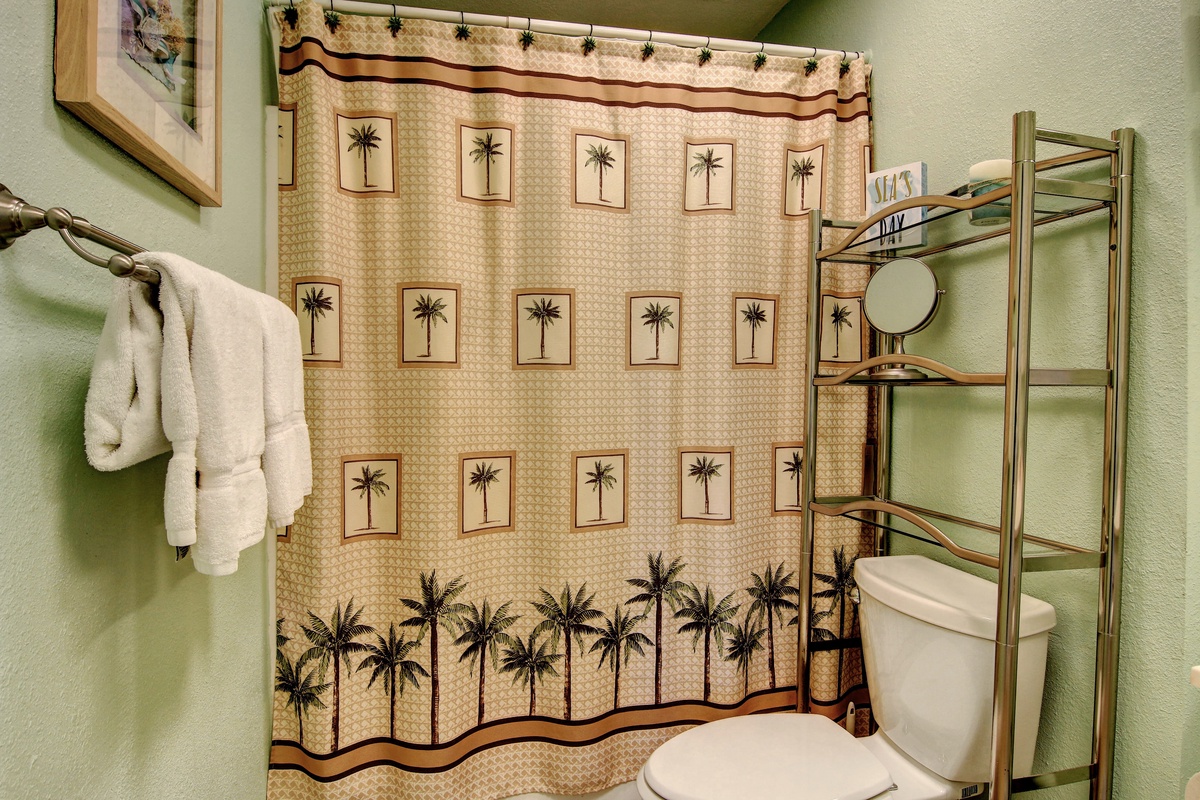 Step into your private oasis with tropical palm-themed decor, plush towels, and thoughtful amenities that make your stay feel like paradise.