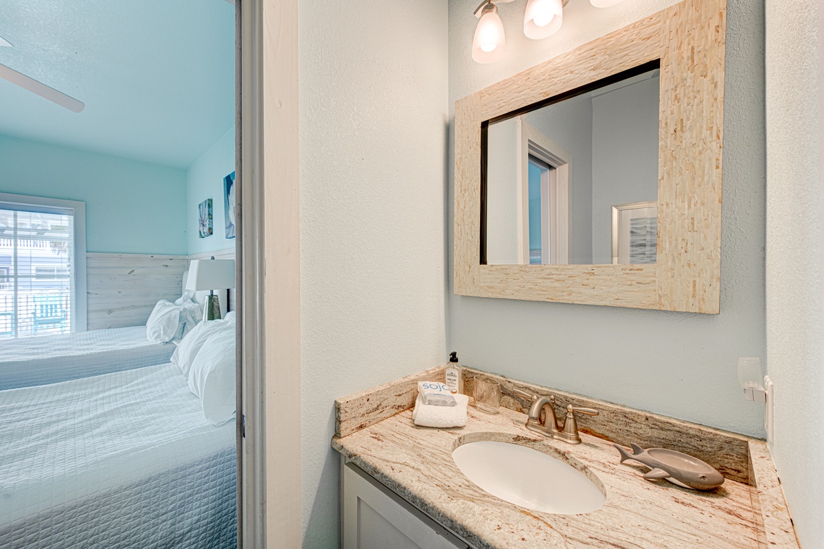 Your beautifully appointed bathroom features elegant granite countertops and warm wood accents, creating a spa-like retreat for your daily refresh.