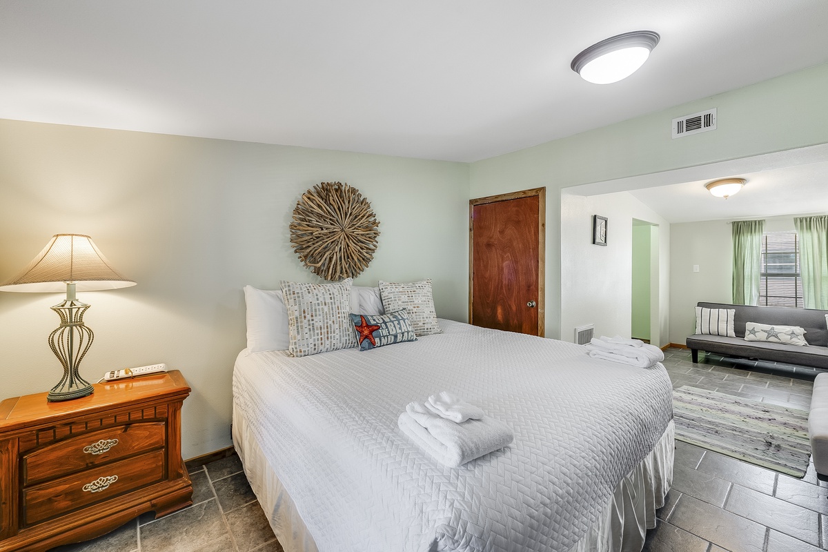 Settle into your serene bedroom featuring a plush bed with fresh linens and thoughtful touches throughout this peaceful space.