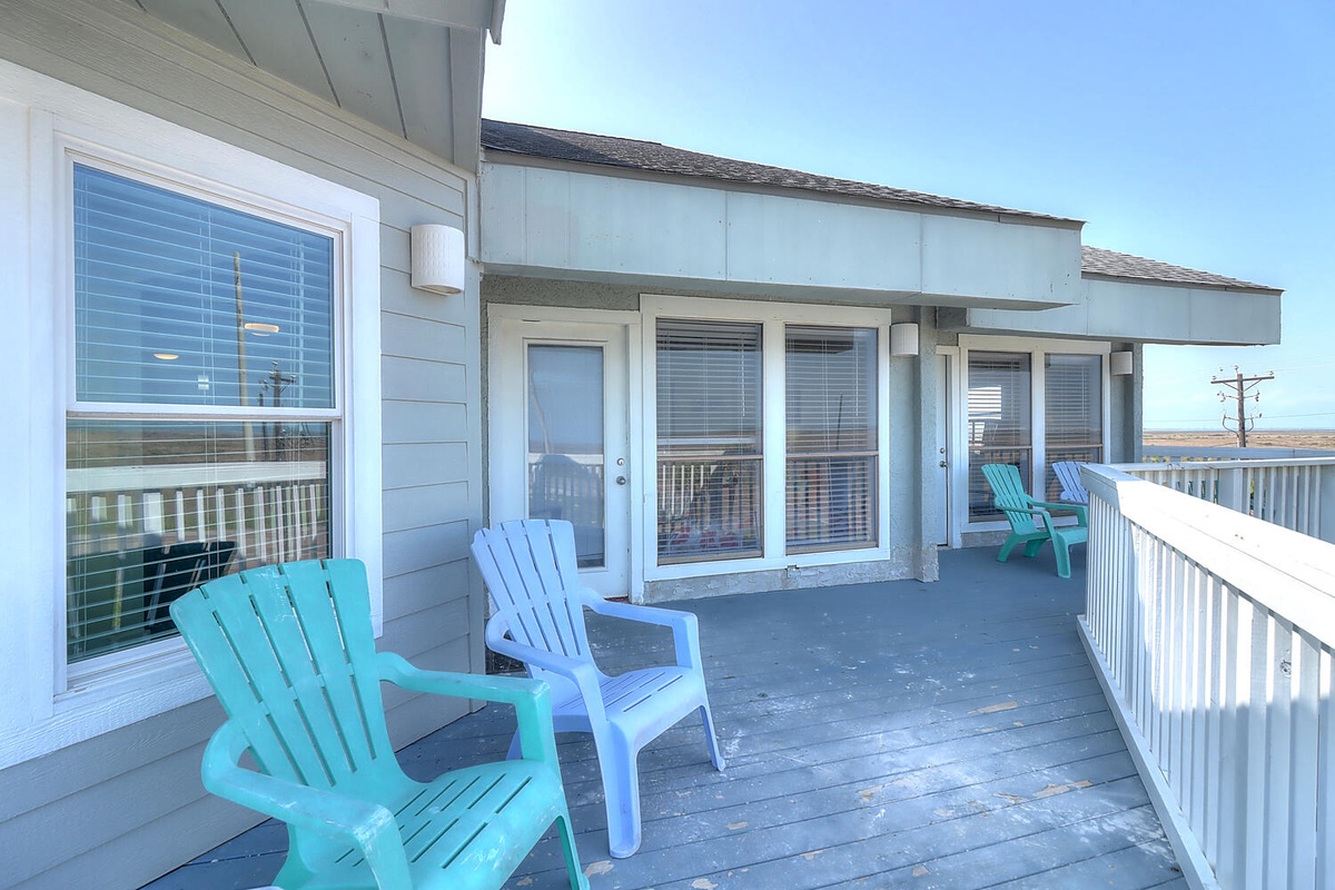 Unwind on your private deck with colorful Adirondack chairs where ocean breezes and coastal views create the perfect spot for morning coffee or evening relaxation.