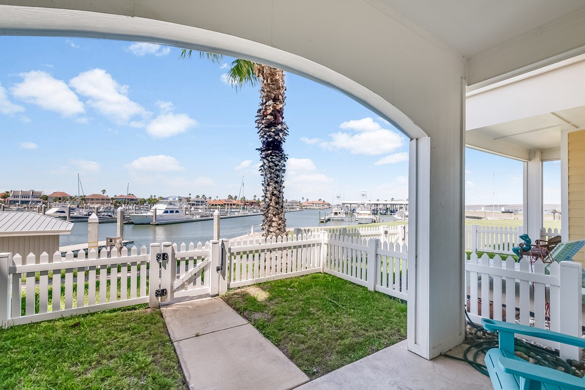 Step onto your private waterfront terrace with sweeping marina views and lush grass area perfect for morning coffee.