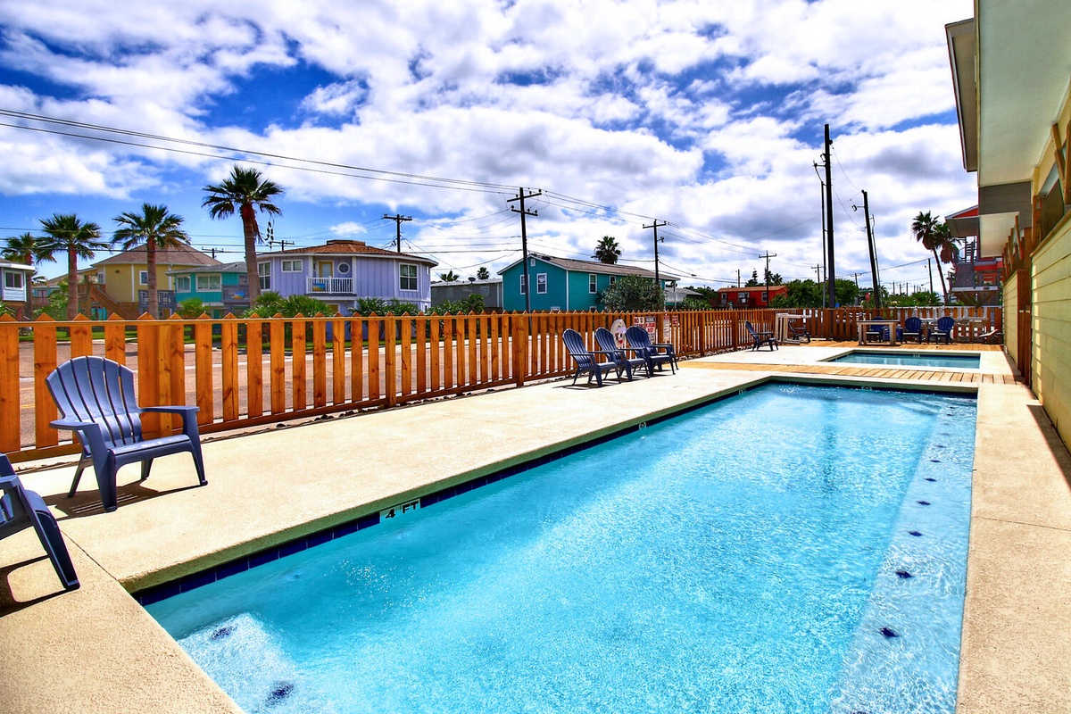 Dive into your private oasis! This sparkling pool beckons for morning swims and afternoon lounging in comfortable poolside chairs.