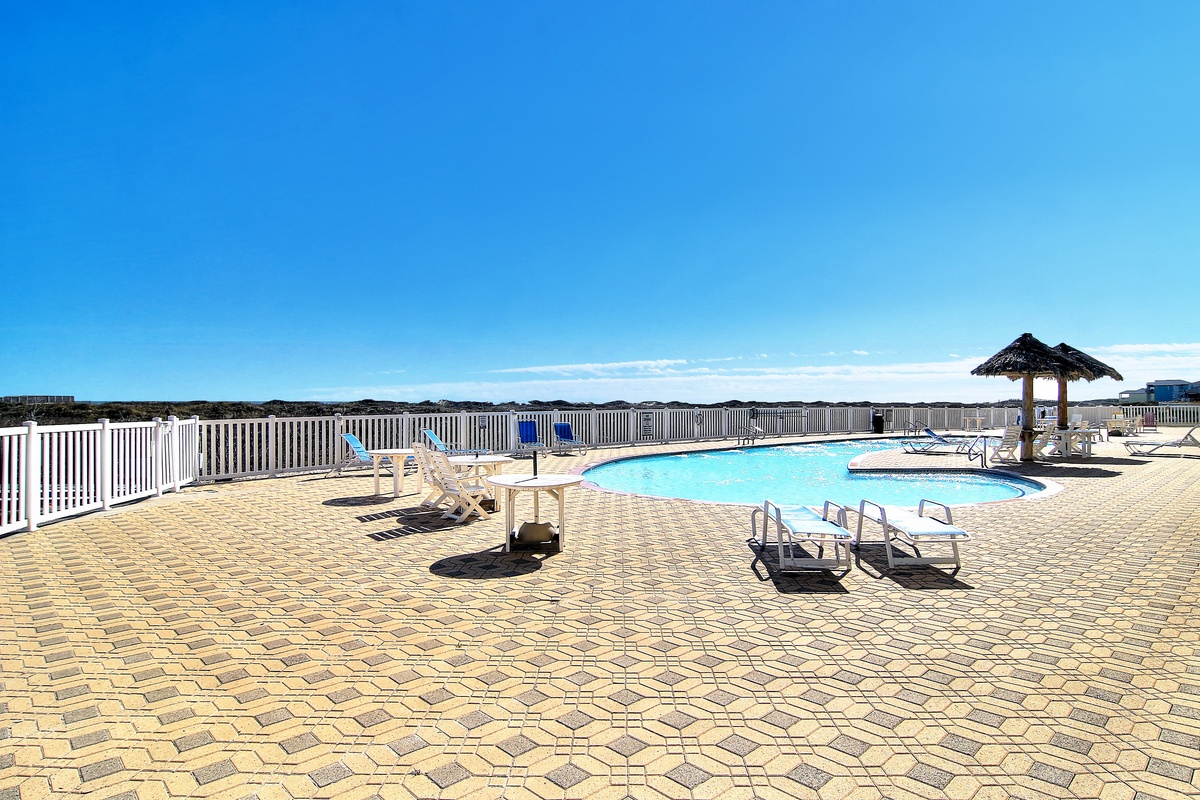 Sparkling pool deck with comfortable loungers where you can soak up the sun and enjoy refreshing swims under endless blue skies.