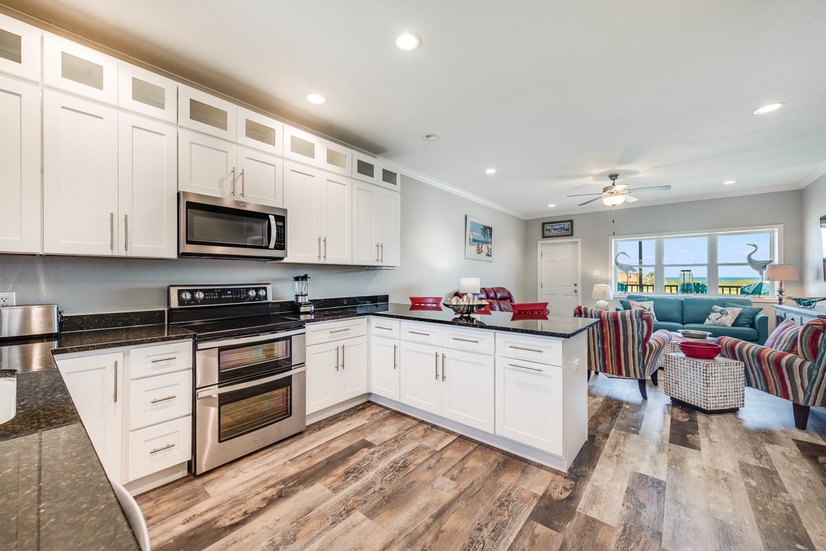 Your fully equipped kitchen opens to the living area, perfect for preparing meals while staying connected with your group.