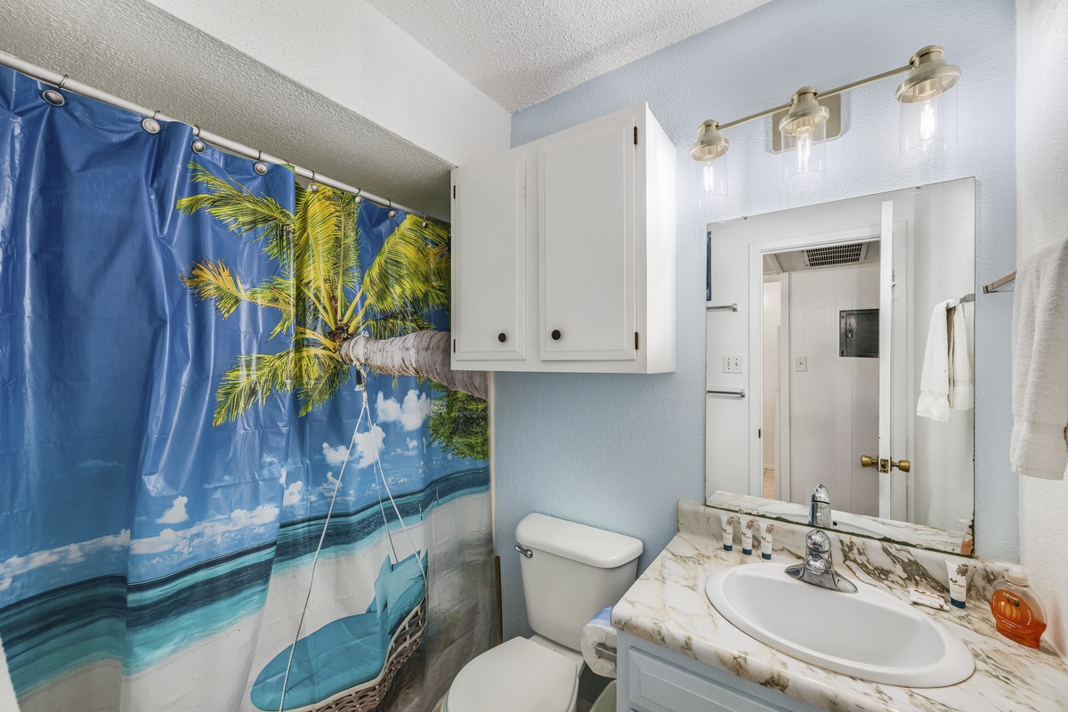 Freshen up in your bright bathroom featuring tropical shower curtain that brings vacation vibes right to your morning routine.